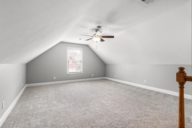 additional living space with vaulted ceiling, ceiling fan, and carpet floors