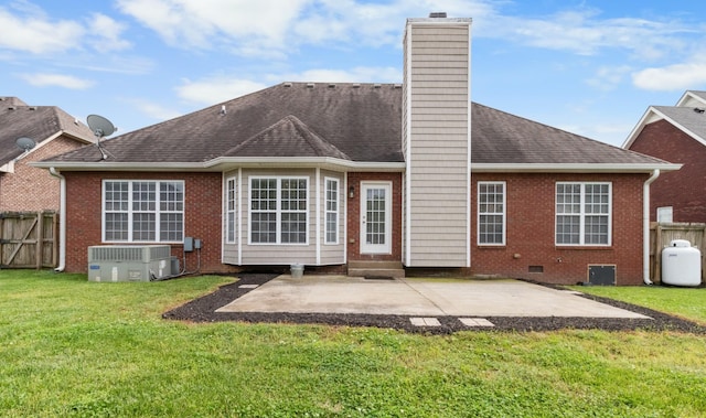 rear view of house with a yard, a patio area, and central AC