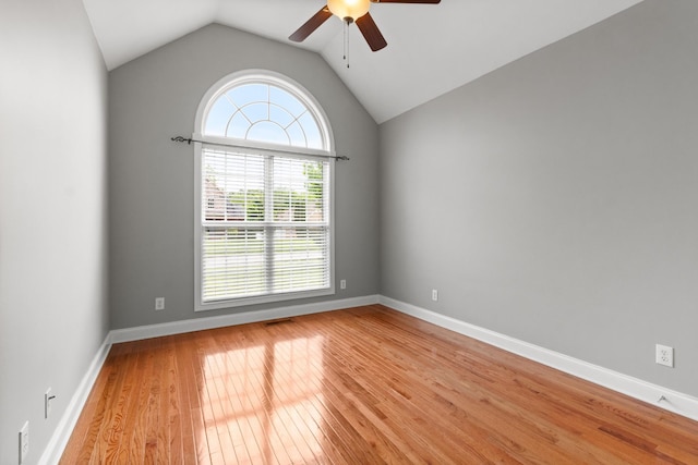 spare room with ceiling fan, light hardwood / wood-style floors, and lofted ceiling