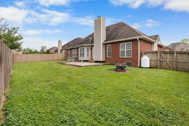 back of house featuring a patio and a yard