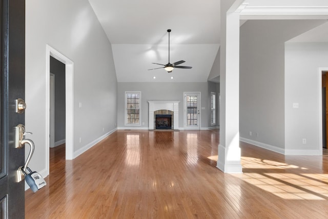 unfurnished living room with high vaulted ceiling, light hardwood / wood-style flooring, and ceiling fan