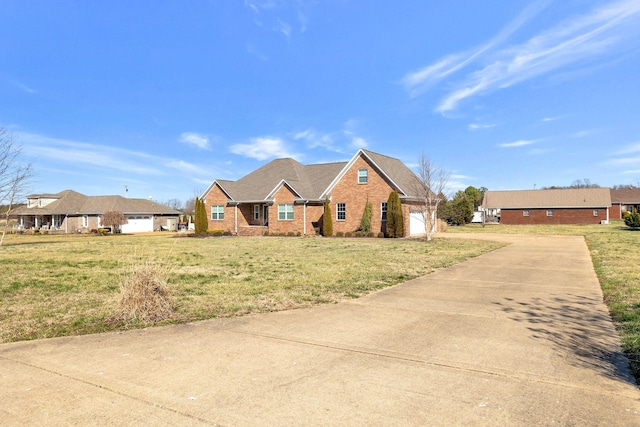 view of front of home featuring an attached garage, brick siding, concrete driveway, and a front yard