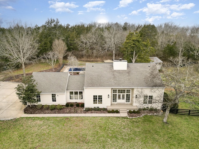 back of house featuring a lawn