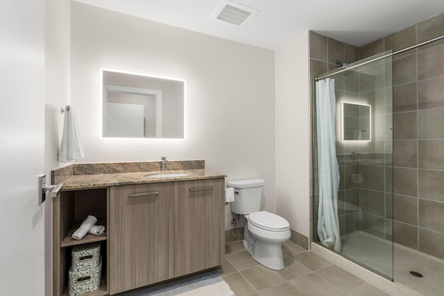 bathroom featuring tile patterned flooring, visible vents, toilet, a tile shower, and vanity