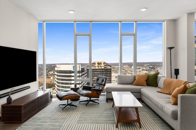 living room with a view of city, floor to ceiling windows, and a healthy amount of sunlight