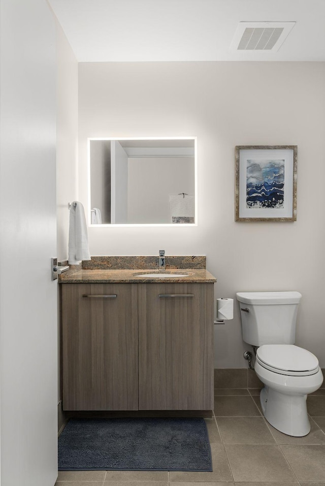 bathroom with tile patterned flooring, visible vents, toilet, and vanity