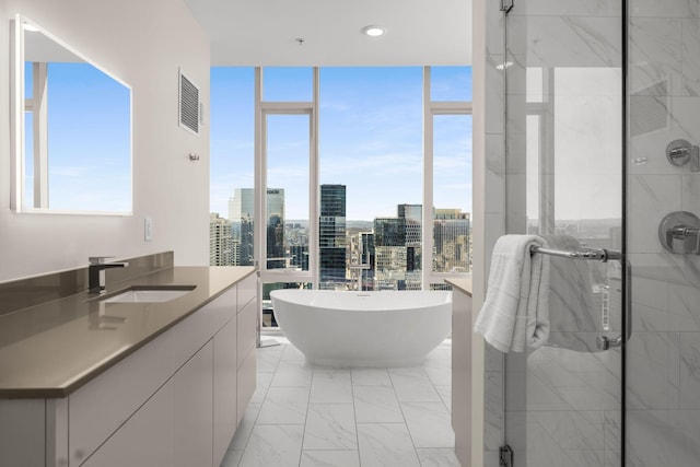 bathroom featuring visible vents, a shower stall, floor to ceiling windows, a city view, and marble finish floor