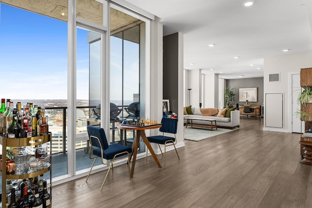 interior space featuring recessed lighting, visible vents, wood finished floors, and expansive windows