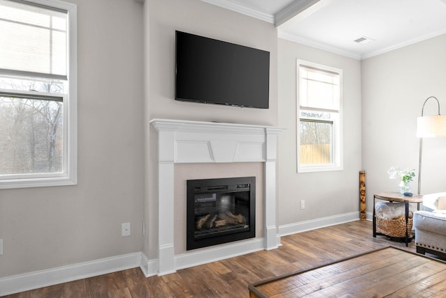 living room featuring hardwood / wood-style flooring and crown molding