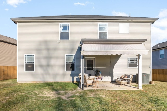 back of house featuring central air condition unit, a patio, outdoor lounge area, and a lawn