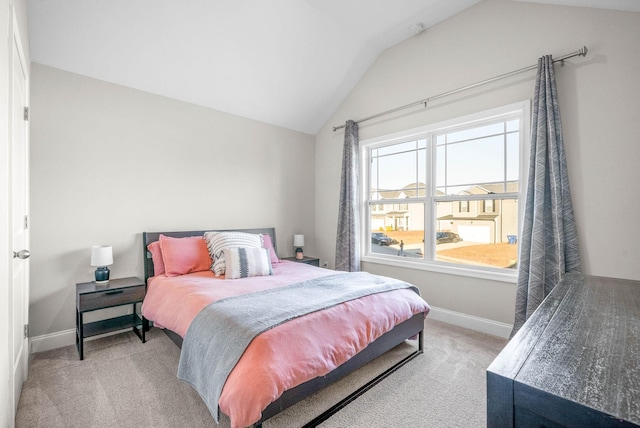 carpeted bedroom with lofted ceiling