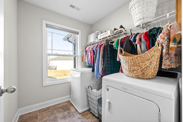 clothes washing area featuring washer and clothes dryer