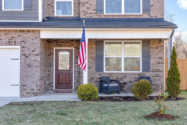 view of exterior entry with a yard