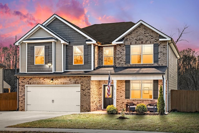 view of front facade featuring driveway, a garage, fence, a front lawn, and brick siding