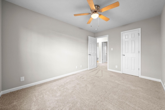 unfurnished bedroom featuring carpet floors and ceiling fan