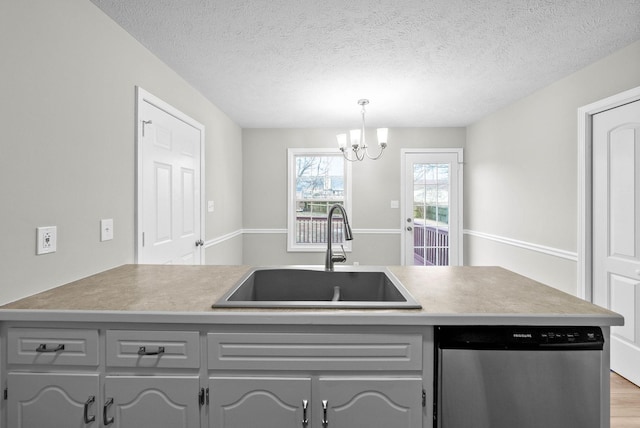 kitchen featuring sink, pendant lighting, dishwasher, gray cabinetry, and light hardwood / wood-style floors