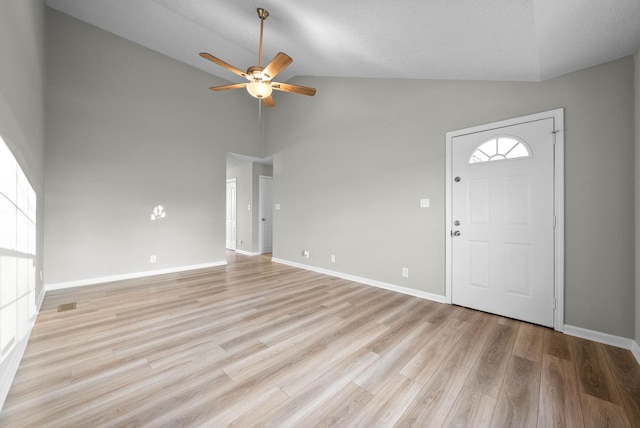 entrance foyer with ceiling fan, light wood-type flooring, and high vaulted ceiling