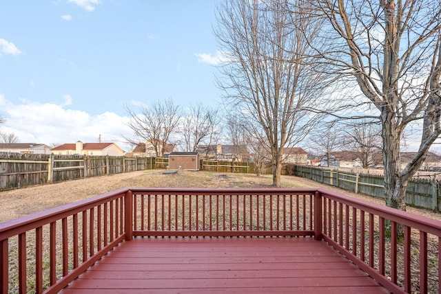 wooden terrace featuring a water view and a storage shed