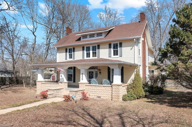 view of front of home featuring a chimney, fence, a porch, and roof with shingles