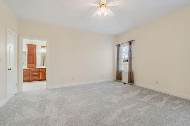 carpeted spare room with ceiling fan