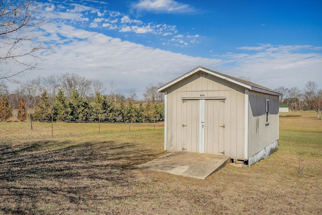 view of outbuilding with a lawn