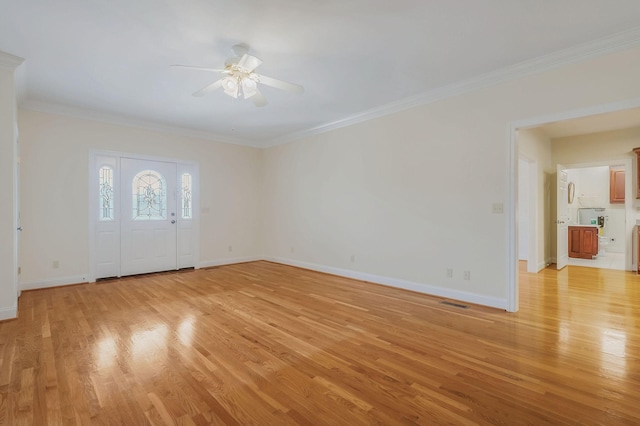 entrance foyer with light hardwood / wood-style flooring, ceiling fan, and ornamental molding