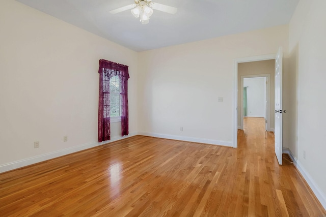 spare room with light wood-type flooring and ceiling fan