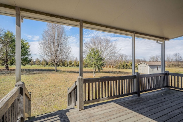 wooden terrace with a yard and a storage shed