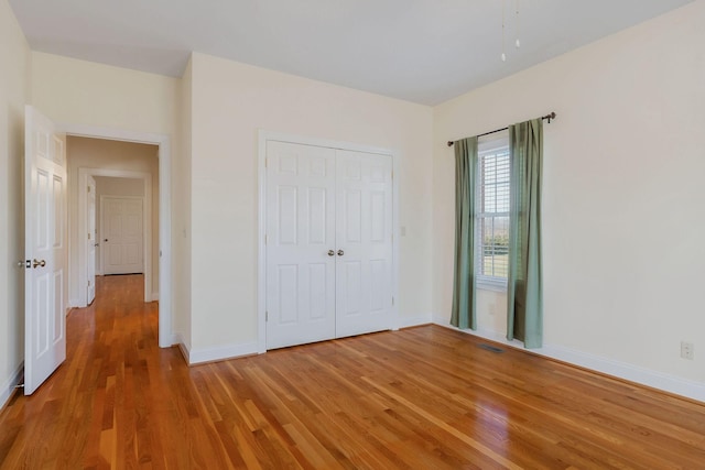 unfurnished bedroom featuring a closet and wood-type flooring