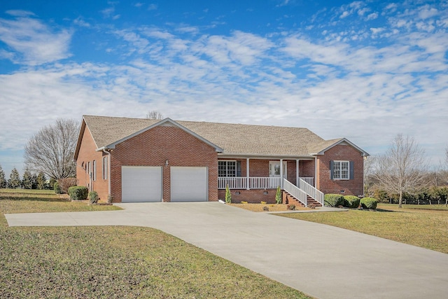 single story home with covered porch, a garage, and a front lawn