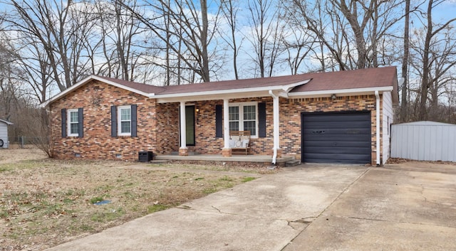 ranch-style home featuring covered porch and a garage