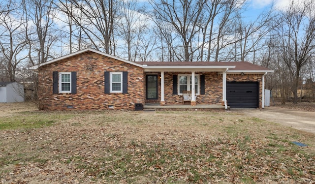 ranch-style house featuring covered porch and a garage