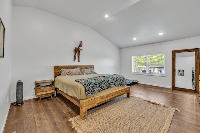 bedroom featuring vaulted ceiling and wood-type flooring