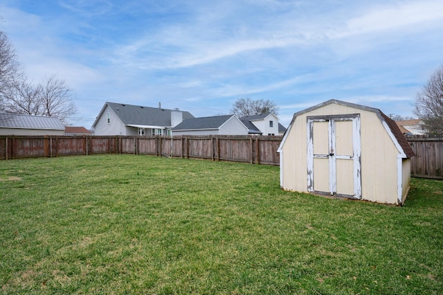 view of yard featuring a fenced backyard, an outdoor structure, and a storage unit