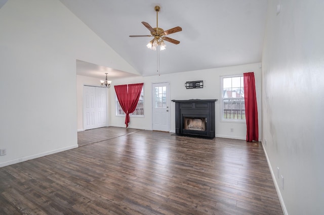 unfurnished living room featuring dark wood-style floors, ceiling fan with notable chandelier, a fireplace, and baseboards