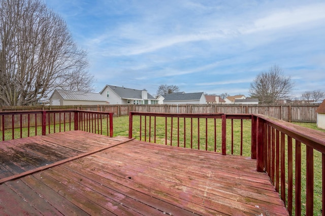 wooden terrace with a yard, a fenced backyard, and a residential view