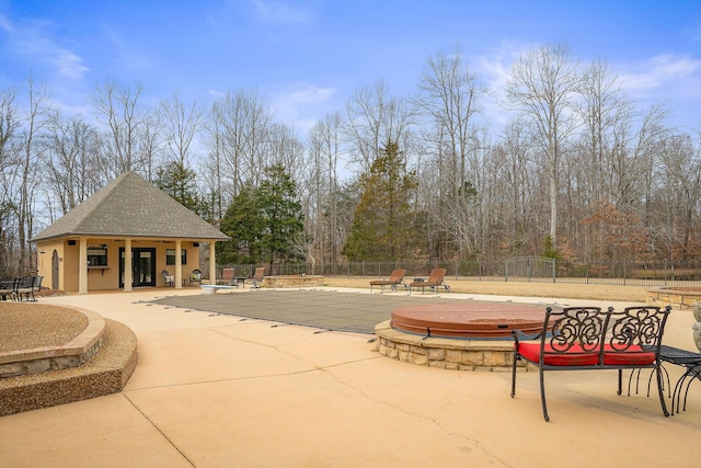 view of swimming pool with an outdoor structure and a patio area