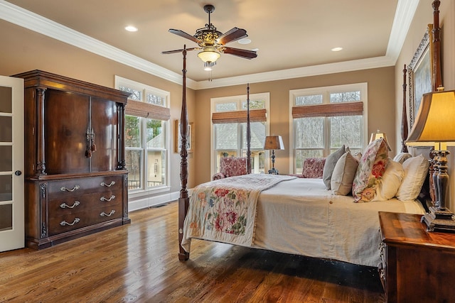 bedroom with crown molding, ceiling fan, and wood-type flooring