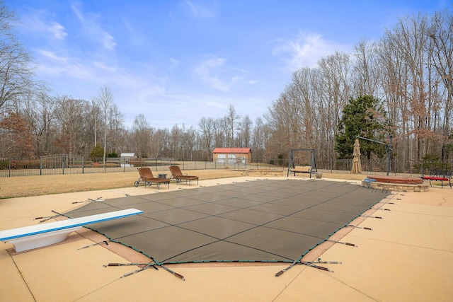 view of swimming pool with a hot tub, a diving board, and a patio area