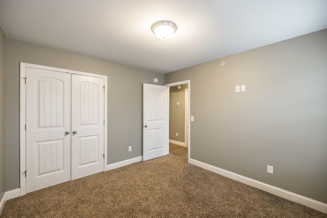 unfurnished bedroom featuring carpet floors and a closet