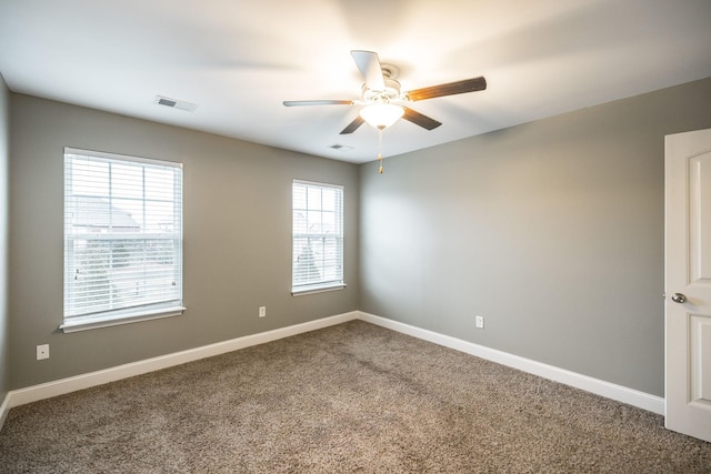 carpeted spare room with ceiling fan