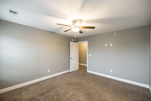 empty room featuring ceiling fan and carpet floors