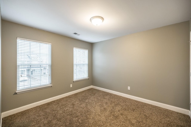 spare room with carpet flooring and a healthy amount of sunlight