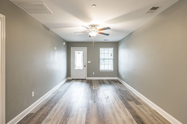 foyer with ceiling fan and wood-type flooring