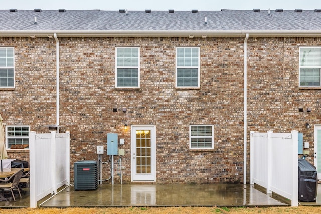 back of house featuring central air condition unit and a patio