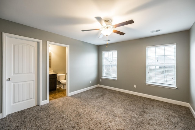 unfurnished bedroom with ceiling fan, carpet flooring, and ensuite bath