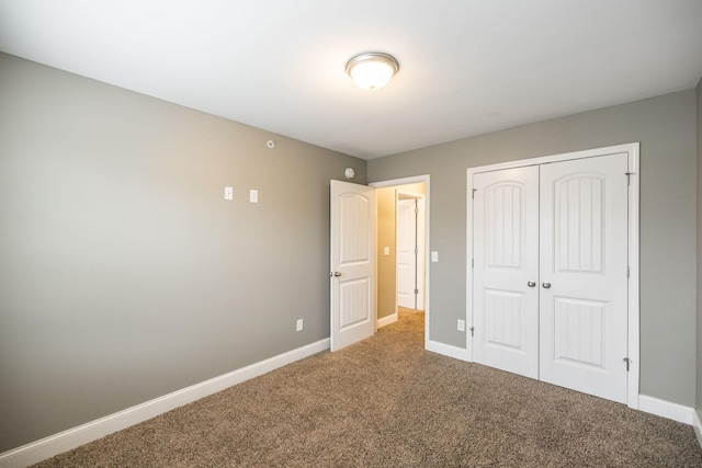 unfurnished bedroom with carpet and a closet