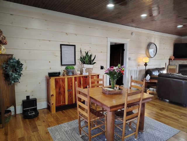 dining room featuring hardwood / wood-style flooring and wooden ceiling