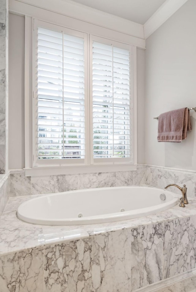 full bathroom featuring a tub with marble appearance and crown molding