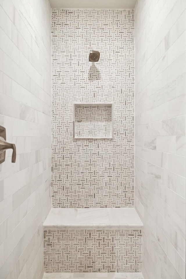 full bath featuring tiled shower